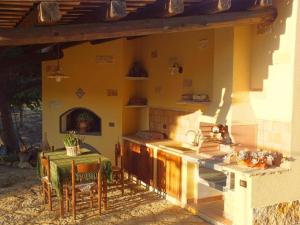 an outdoor kitchen with a table and a stove at Siciliantica - Rilievo in Rilievo