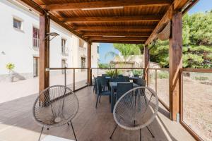 a patio with a table and chairs on it at Siciliantica - Rilievo in Rilievo