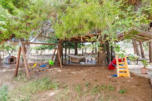 a playground with a tree and a swing at Siciliantica - Rilievo in Rilievo