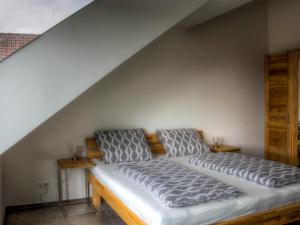 a bedroom with a large bed in a attic at Alpenblick 3 in Lindau-Bodolz