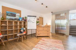 a room with a desk and a dresser and chairs at Apartment Cater Residence Bun Ste in San Vigilio Di Marebbe