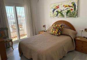 a bedroom with a bed and a painting on the wall at Salida Del Sol in Nerja +27 photos