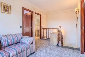 a living room with a couch and a staircase at Villa natura 20 km de las playas in Sils +31 photos