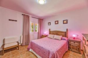 a bedroom with a bed and a chair and two lamps at Can Parets in Santanyi +17 photos