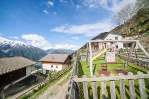 a playground on the side of a mountain at Flatschhof - Apartment Cevedale in Kastelbell-Tschars