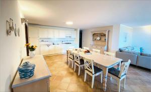 a kitchen and dining room with a table and chairs at Apartment Ida Isuledda 1 in San Teodoro