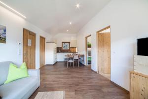 a living room with a couch and a table at Flatschhof - Apartment Cevedale in Kastelbell-Tschars +10 photos