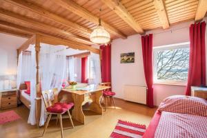 a bedroom with a table and a bed and a desk at Das kleine Paradies in Pürgen
