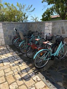 a row of bikes parked next to a stone wall at La Casa Vacanza Dei Sogni in Paestum