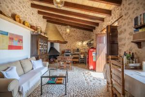a living room with a couch and a table at Can Pulit in El Port de la Selva