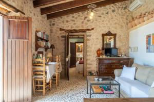 a living room with a couch and a table at Can Pulit in El Port de la Selva