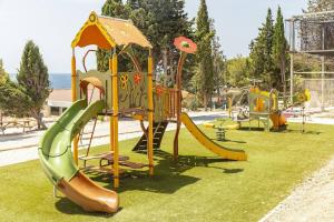 a park with a playground with a slide at Camping Lou Soulei 218 in Carry-le-Rouet