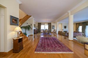 an open living room with a rug on a hard wood floor at Supreme and Classy Pool Residence in Paianía