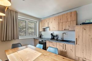 a kitchen with wooden cabinets and a wooden table at Luisalle Top 5 in Auffach