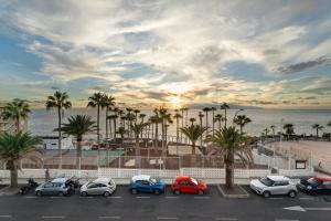 a parking lot with cars parked next to the beach at Casa Laly in Callao Salvaje