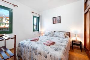 a bedroom with a bed with two pillows on it at Casa Laly in Callao Salvaje