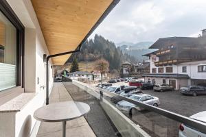 a balcony with a table and a parking lot at Luisalle Top 5 in Auffach