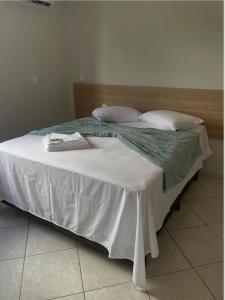 a bed with two books on top of it at Hotel Dias in Mucurici