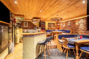 a restaurant with wooden ceilings and tables and blue stools at Ferienwohnung Zur Imme in Lindau