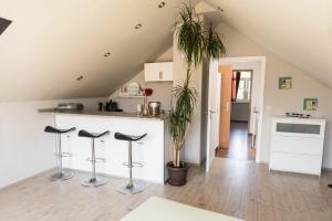 a kitchen with a counter and stools in a room at Haus Jäschke in Bremerhaven