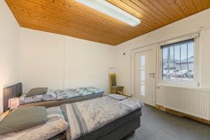 a bedroom with two beds and a window at 2 Bett Apartment a d A8 - W5 in Beckingen