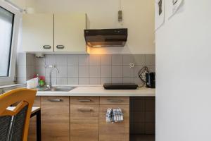 a kitchen with a sink and a counter top at 2 Bett Apartment a d A8 - W5 in Beckingen