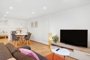 a living room with a couch and a flat screen tv at Ferienwohnung Apfelwiese in Meßstetten