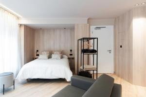 a bedroom with a white bed and a couch at Ca Gracia Bocairent in Bocairent