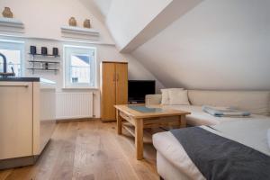 a living room with a couch and a table at Ferienwohnung Reck in Aulendorf +16 photos