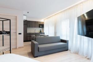 a living room with a couch and a kitchen at Ca Gracia Bocairent in Bocairent