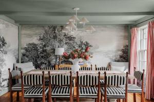 a dining room with a table and chairs at Historic Island Home Heated Pool in Nantucket