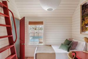 a small room with a bed and a window at Historic Island Home Heated Pool in Nantucket