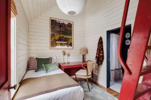 a small bedroom with a bed and a desk at Historic Island Home Heated Pool in Nantucket