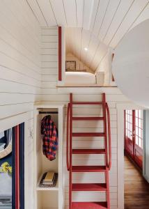 a staircase in a tiny house with a ladder at Historic Island Home Heated Pool in Nantucket +30 photos