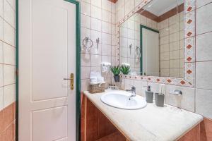 a bathroom with a sink and a mirror at Spyridoula Studio 12 in Paleokastritsa +27 photos