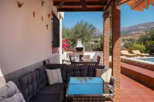 a patio with a couch and a table at Villa ju-mi in El Cerro