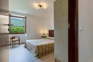 a bedroom with a bed and a window at Nonna Gina in Tignale +25 photos