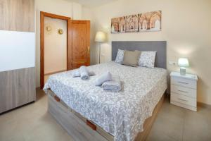 a bedroom with a bed with two towels on it at Villa ju-mi in El Cerro +19 photos