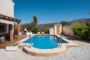 a swimming pool in the backyard of a house at Villa ju-mi in El Cerro
