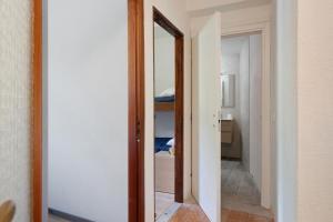 an open door to a bedroom with a mirror at Marilleva 900 Terminal in Mezzana +24 photos