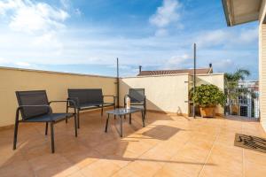 a patio with two chairs and a table on top at Ferran in Deltebre