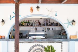 a bar with an archway in a kitchen at Livadia Beach Suite in Tílos