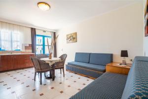 a living room with a couch and a table at Livadia Beach Suite in Tílos +16 photos