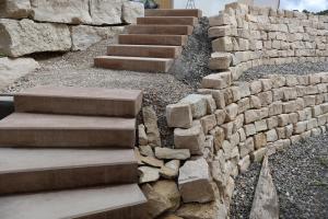 a stone wall and stairs next to a brick wall at Ferienwohnung Spielmann in Sauldorf