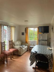 a living room with a table and a couch at Cabañas Isidora in Dalcahue