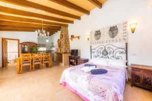 a bedroom with a bed and a dining room at Can Lopez Vara in Campos +27 photos