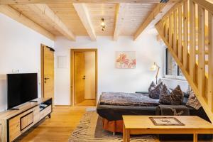 a living room with a bed and a tv at Apartment Alte Mühle in Scharnitz