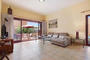 a living room with a couch and a table at La Palmera de la Oliva in La Oliva