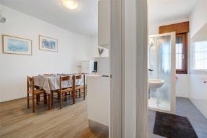 a kitchen and dining room with a table and a dining room at Villa Trentina in Lido di Jesolo +63 photos