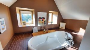 a large bathroom with a large tub and windows at La maison jaune - 3ch - 6pers in Loctudy +14 photos